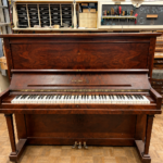 1922 Heintzman Upright Piano Model O in a Walnut Finish.