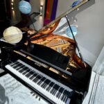 1990 August Förster Grand Piano Model 215 in a Polished Ebony Finish.