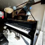 1990 August Förster Grand Piano Model 215 in a Polished Ebony Finish.