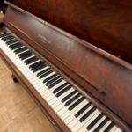 1922 Heintzman Upright Piano Model O in a Walnut Finish.